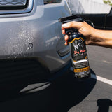 Bug & Tar Remover Spray being applied to car bumper to remove bugs
