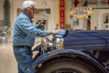 Jay Leno using a premium microfibre towel to polish his car with our Quick Detailer spray to remove marks and dust.