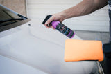 Spraying Clay Mitt Lube onto car bonnet for paint correction with clay mitt 