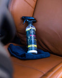 Interior Detailer, interior cleaning spray with microfibre towels on leather seats.